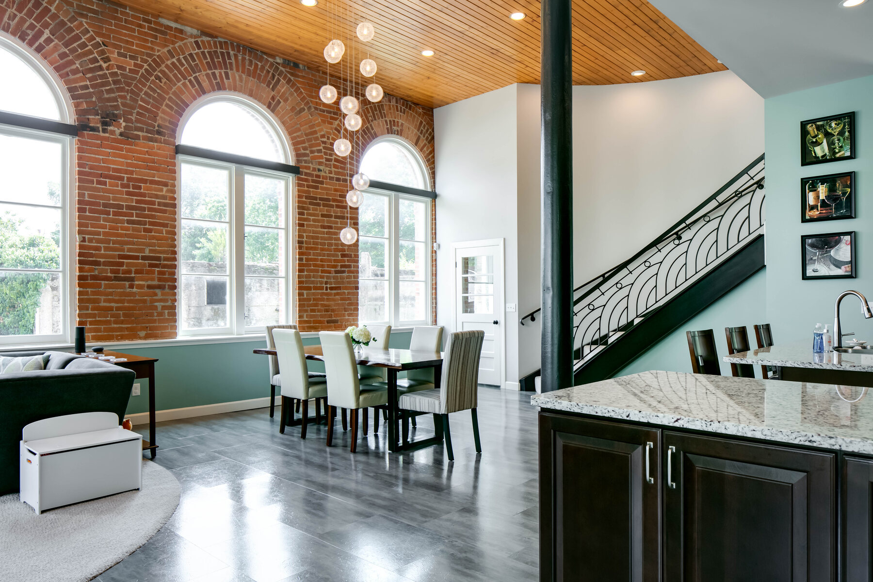 Overall first-floor view with dining and curved stair